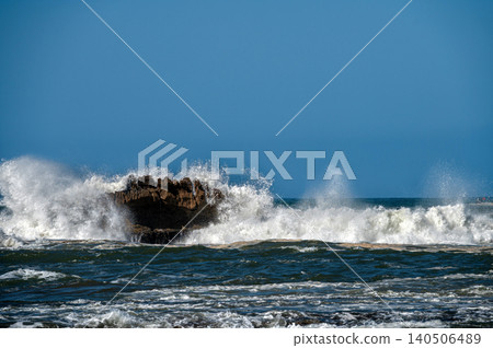 Waves crashing against rocky shoreline in Essaouira, Morocco on a clear day Waves crashing against rocky shoreline in Essaouira, Morocco on a clear day 140506489