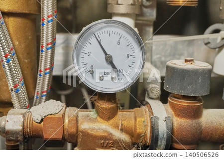 Close-Up of a Pressure Gauge Measuring Bar in an Industrial Setting with Pipelines and Valves Close-Up of a Pressure Gauge Measuring Bar in an Industrial Setting with Pipelines and Valves 140506526
