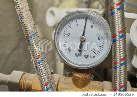 Detailed Close-Up of a Pressure Gauge with Braided Hoses and Measurement Indicators in Bar 140506529