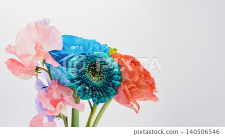 Colorful flower bouquet: blue gerberas, roses, ranunculus, and sweet peas. White background. Copy space. Colorful flower bouquet: blue gerberas, roses, ranunculus, and sweet peas. White background. Copy space. 140506546