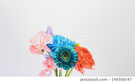 Colorful flower bouquet: blue gerberas, roses, ranunculus, and sweet peas. White background. Copy space. Colorful flower bouquet: blue gerberas, roses, ranunculus, and sweet peas. White background. Copy space. 140506547