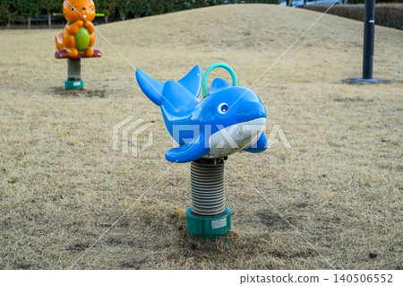 Dolphin-shaped spring play equipment installed in the park Dolphin-shaped spring play equipment installed in the park 140506552