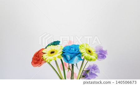 Colorful flower arrangement: blue roses, gerberas, ranunculus, and sweet peas against a white background. Colorful flower arrangement: blue roses, gerberas, ranunculus, and sweet peas against a white background. 140506673