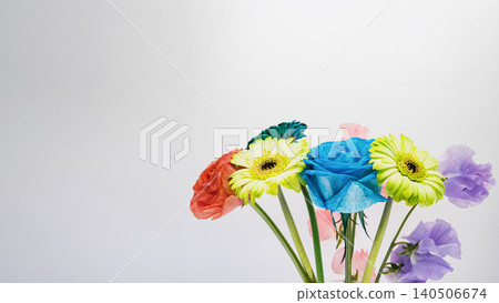 Colorful flower arrangement: blue roses, gerberas, ranunculus, and sweet peas against a white background. Colorful flower arrangement: blue roses, gerberas, ranunculus, and sweet peas against a white background. 140506674