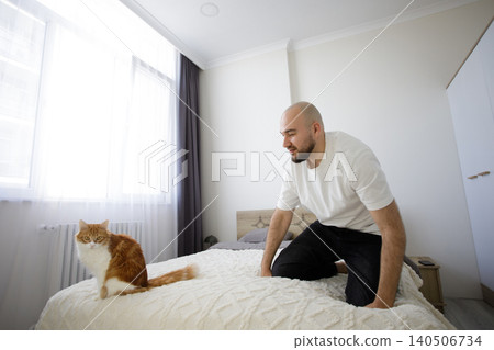 Happy man and cat at home Happy man and cat at home 140506734