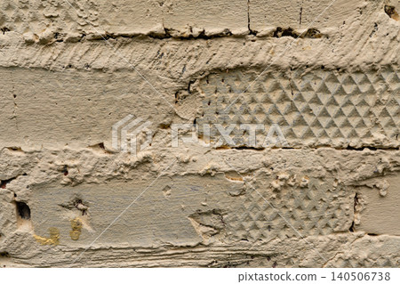 Detailed texture of rough beige plastered brick wall surface with indentations Detailed texture of rough beige plastered brick wall surface with indentations 140506738