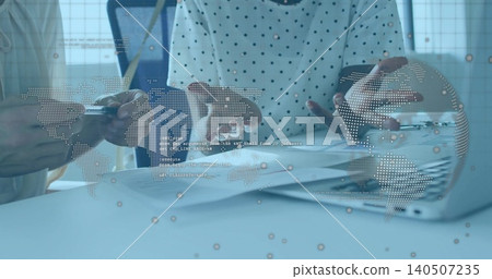 Reviewing two colleagues in light blazer and dotted top studying charts at office with data overlay Reviewing two colleagues in light blazer and dotted top studying charts at office with data overlay 140507235