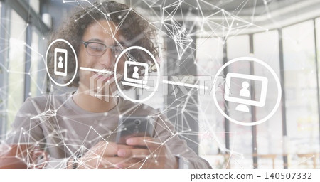 Holding phone, man with glasses wearing gray top smiling, scrolling at cafe, network icons, watch 140507332