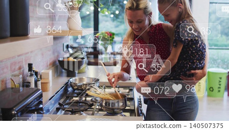 Stirring mom holding child in home kitchen on gas cooktop, wearing red blouse with social icons 140507375