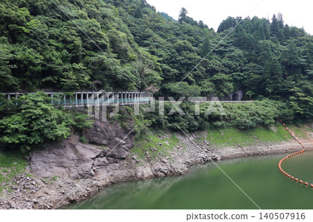 A prefectural road running along the Hyugami Dam Lake and a tunnel on the mountainside A prefectural road running along the Hyugami Dam Lake and a tunnel on the mountainside 140507916