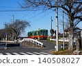 A local train on the Mooka Railway passes a level crossing in Tochigi Prefecture. 140508027