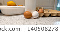 Eggs, milk, and lemon showcasing essential farm products on a speckled countertop, representing wholesome ingredients for cooking and healthy breakfast meals in a kitchen setting. 140508278