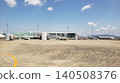 A parking area and passenger plane at a regional airport on a clear day. 140508376