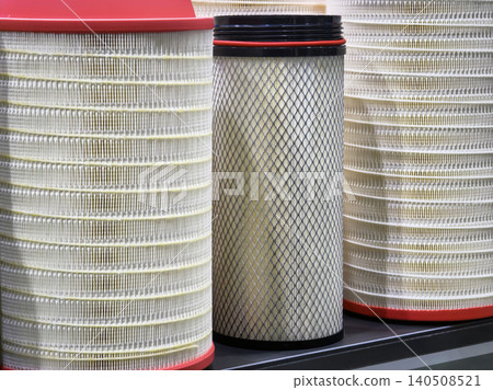 Workers gather air filters in a storage area while preparing for a maintenance task on a busy day in a large facility 140508521
