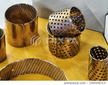 Metal parts are arranged on a yellow surface at a display Metal parts are arranged on a yellow surface at a display 140508553