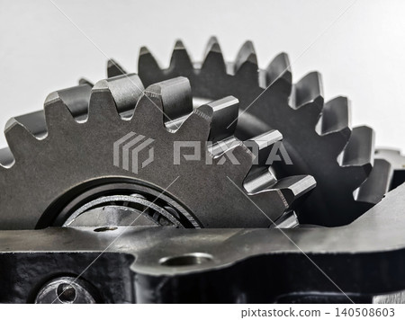 Close view of metal gears showing parts of a machine in a workshop during daylight hours Close view of metal gears showing parts of a machine in a workshop during daylight hours 140508603