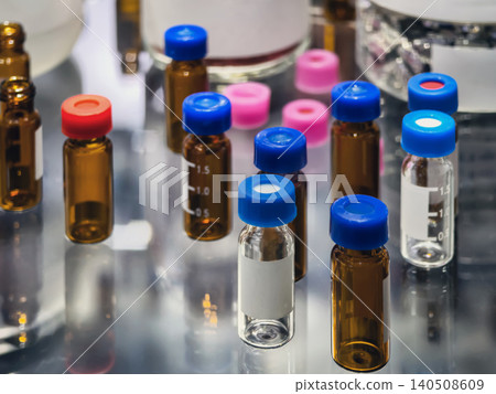 Different types of vials and containers with liquids arranged on a lab bench during a research session in a laboratory setting Different types of vials and containers with liquids arranged on a lab bench during a research session in a laboratory setting 140508609