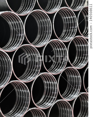Pipes arranged in a factory setting showing metal construction and industrial design Pipes arranged in a factory setting showing metal construction and industrial design 140508611