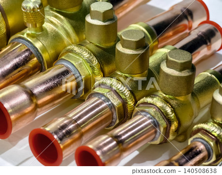 Different types of brass and copper valves and fittings displayed on a white surface during Different types of brass and copper valves and fittings displayed on a white surface during 140508638
