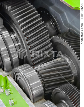 Gears and machinery highlight working parts in an industrial setting during daylight hours 140508658