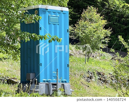 Blue portable toilets used in outdoor facilities and construction sites Blue portable toilets used in outdoor facilities and construction sites 140508724