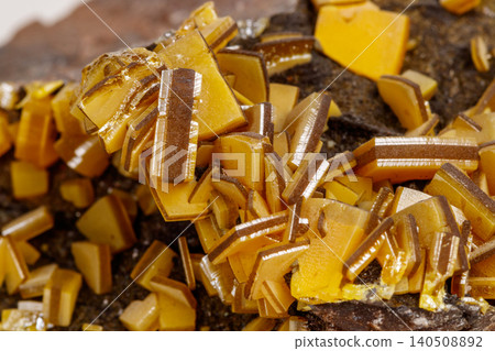 Macro mineral stone yellow Wulfenite on a white background Macro mineral stone yellow Wulfenite on a white background 140508892