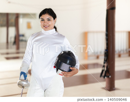 Latina woman in white overalls in fencing club Latina woman in white overalls in fencing club 140509046