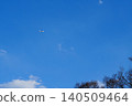 A passenger plane flying in the blue sky and a vast expanse of sky copy space 140509464