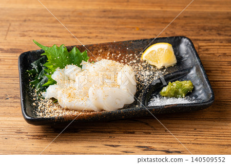 Fresh raw octopus sashimi served simply with sesame oil and salt. Fresh raw octopus sashimi served simply with sesame oil and salt. 140509552