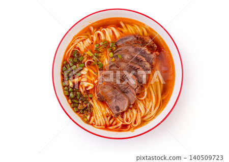Spicy Chinese beef noodle soup with sliced beef shank and scallions, top view 140509723