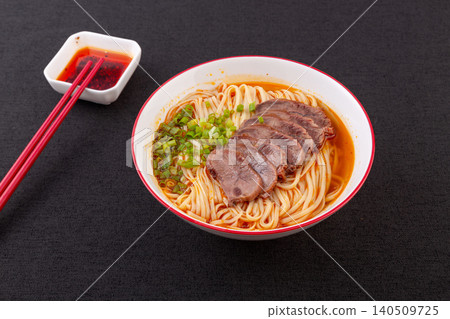 Traditional Chinese beef noodle soup with sliced shank on marble table, side view Traditional Chinese beef noodle soup with sliced shank on marble table, side view 140509725