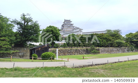 The scenery of Himeji Castle surrounded by stone walls and greenery. The scenery of Himeji Castle surrounded by stone walls and greenery. 140509919