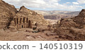A distant view of Ad Deir, part of the Petra ruins, perched on a vast rocky mountain. 140510319