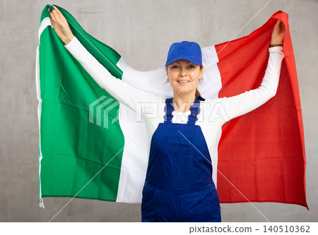Smiling adult woman in uniform holding Italy flag Smiling adult woman in uniform holding Italy flag 140510362