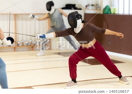 female athlete participates in fencing training fights female athlete participates in fencing training fights 140510657