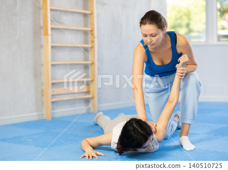 Women in sportswear on a self-defence workout in gym 140510725