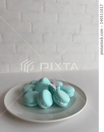 A refreshing mint blue fake sweets macaron and butterfly. A refreshing mint blue fake sweets macaron and butterfly. 140511017