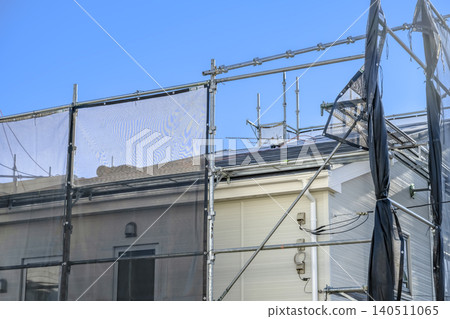 Roof repair work on a detached house: scaffolding and open sky 140511065