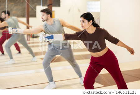 Latino American woman at a group fencing lesson 140511125