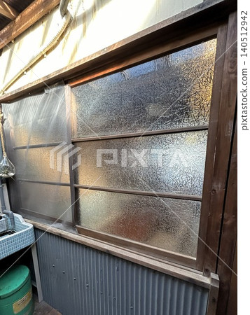 The wall of an old house made with Showa-era patterned glass. The wall of an old house made with Showa-era patterned glass. 140512942