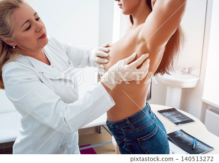 Doctor get examining breast of young woman. Consultation with gynecologist. 140513272