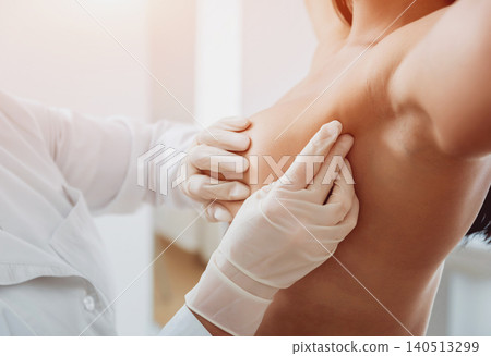 Doctor get examining breast of young woman. Consultation with gynecologist. 140513299