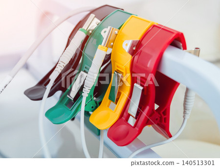 Doctor with electrocardiogram equipment making cardiogram test to patient in clinic. Doctor with electrocardiogram equipment making cardiogram test to patient in clinic. 140513301