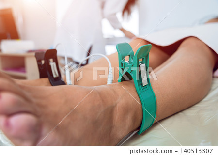 Doctor with electrocardiogram equipment making cardiogram test to patient in clinic. Doctor with electrocardiogram equipment making cardiogram test to patient in clinic. 140513307