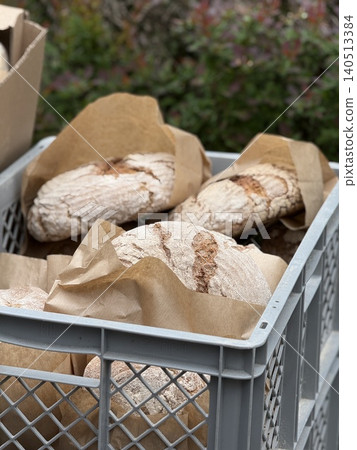 Artisan bread in a crate wrapped in brown paper, suitable for bakery background Artisan bread in a crate wrapped in brown paper, suitable for bakery background 140513384