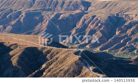 Van driving on road through Gorafe badlands in Spain Van driving on road through Gorafe badlands in Spain 140513938