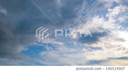 Majestic dramatic sky landscape with heavy dark rain clouds mixing with bright white clouds and light blue patches, capturing dynamic nature weather changes, wide-angle shot. Majestic dramatic sky landscape with heavy dark rain clouds mixing with bright white clouds and light blue patches, capturing dynamic nature weather changes, wide-angle shot. 140514007