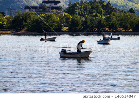 A scene of clam fishing on Lake Togo in the morning. A scene of clam fishing on Lake Togo in the morning. 140514047