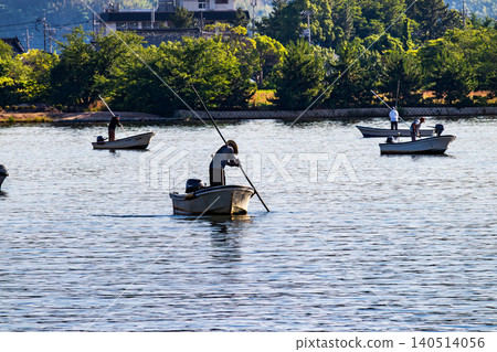 A scene of clam fishing on Lake Togo in the morning. A scene of clam fishing on Lake Togo in the morning. 140514056