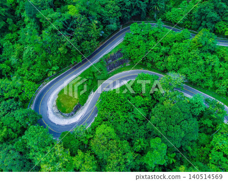 Aerial View of Winding Road Through Lush Tropical Forest in Tapak Tuan, Aceh Aerial View of Winding Road Through Lush Tropical Forest in Tapak Tuan, Aceh 140514569